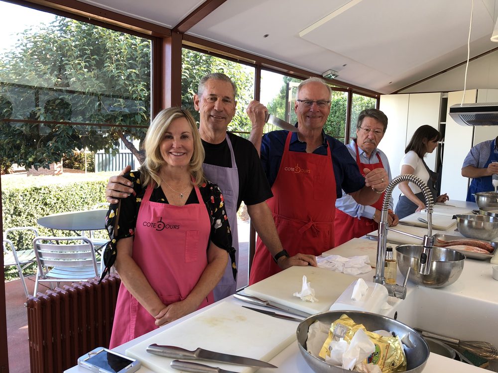 A group gathered around the counter at a hands-on cooking class